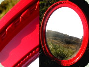 Oval spegel med röd
                          ram och fasettslipat glas etikettmärkt Ota