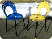 A pair of Swedish side
                          chairs in black lacquered metal with plastic
                          strapping