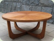 Teak veneer round
                          occasional table on skids