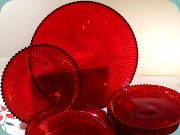 Gullaskruf Reffla
                          Arthur Percy assietter och stort fat i rött
                          glas 50-tal