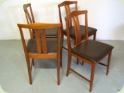 Set of four teak
                          dining chairs with dark brown vinyl
                          upholstery