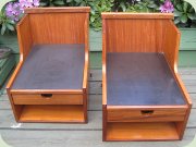Pair of 50's wall
                          mounted bedside tables / shelves with drawer,
                          teak with black laminate on top.