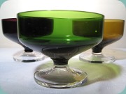 4 dessert bowls in
                          purple, green and amber with leg in clear
                          glass